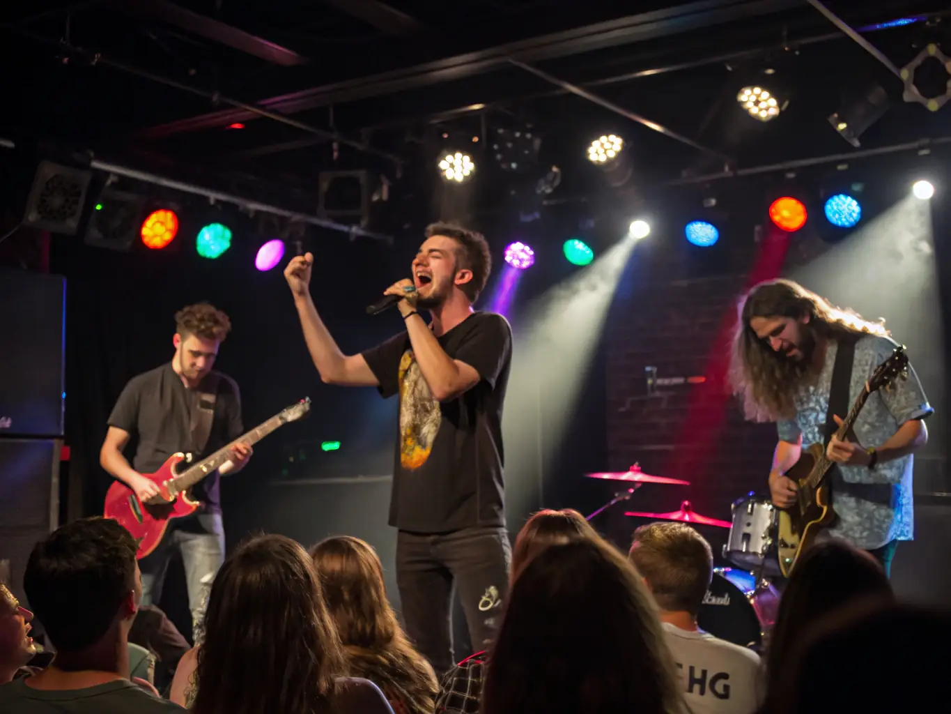 An image of a lively stage with performers and an engaged audience, capturing the vibrant atmosphere of a live event at the venue.